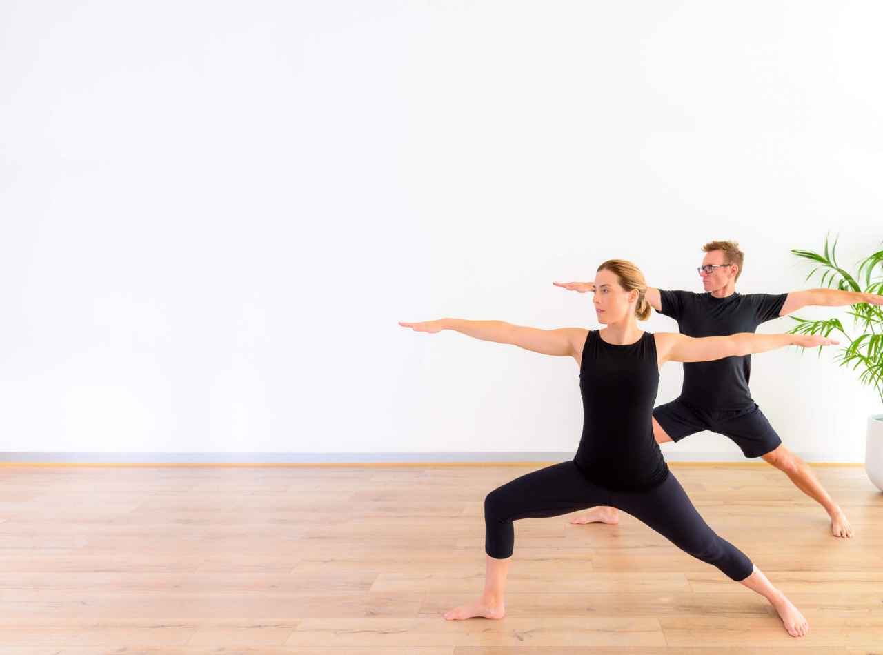 Stuart & Danielle Harrison In A Yoga pose